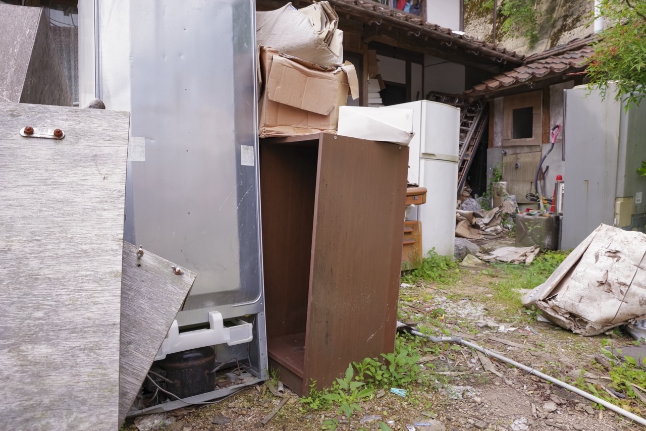 不用品が散乱している廃屋・不法投棄現場